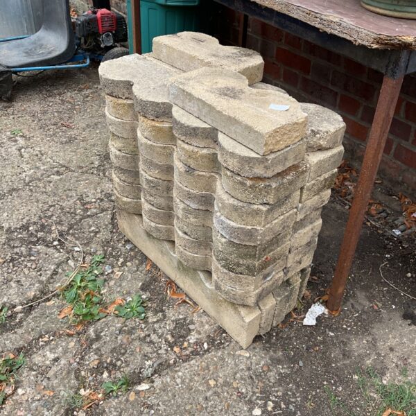 Weathered concrete garden edging stones for landscaping projects.