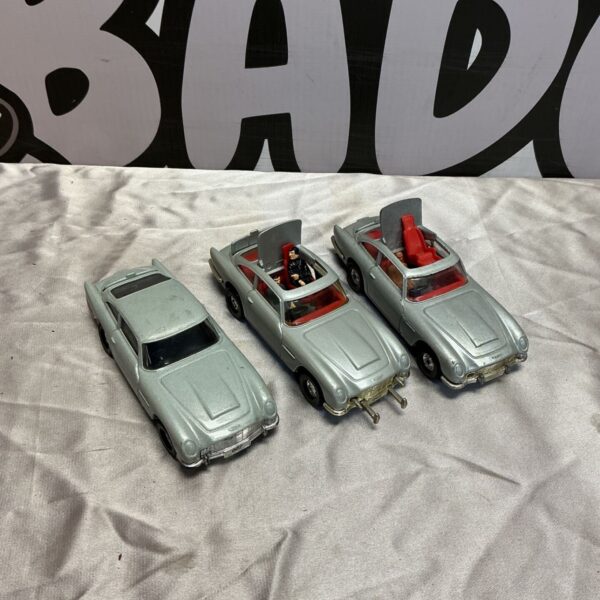 Three Corgi James Bond Aston Martin DB5 diecast cars in a lot.