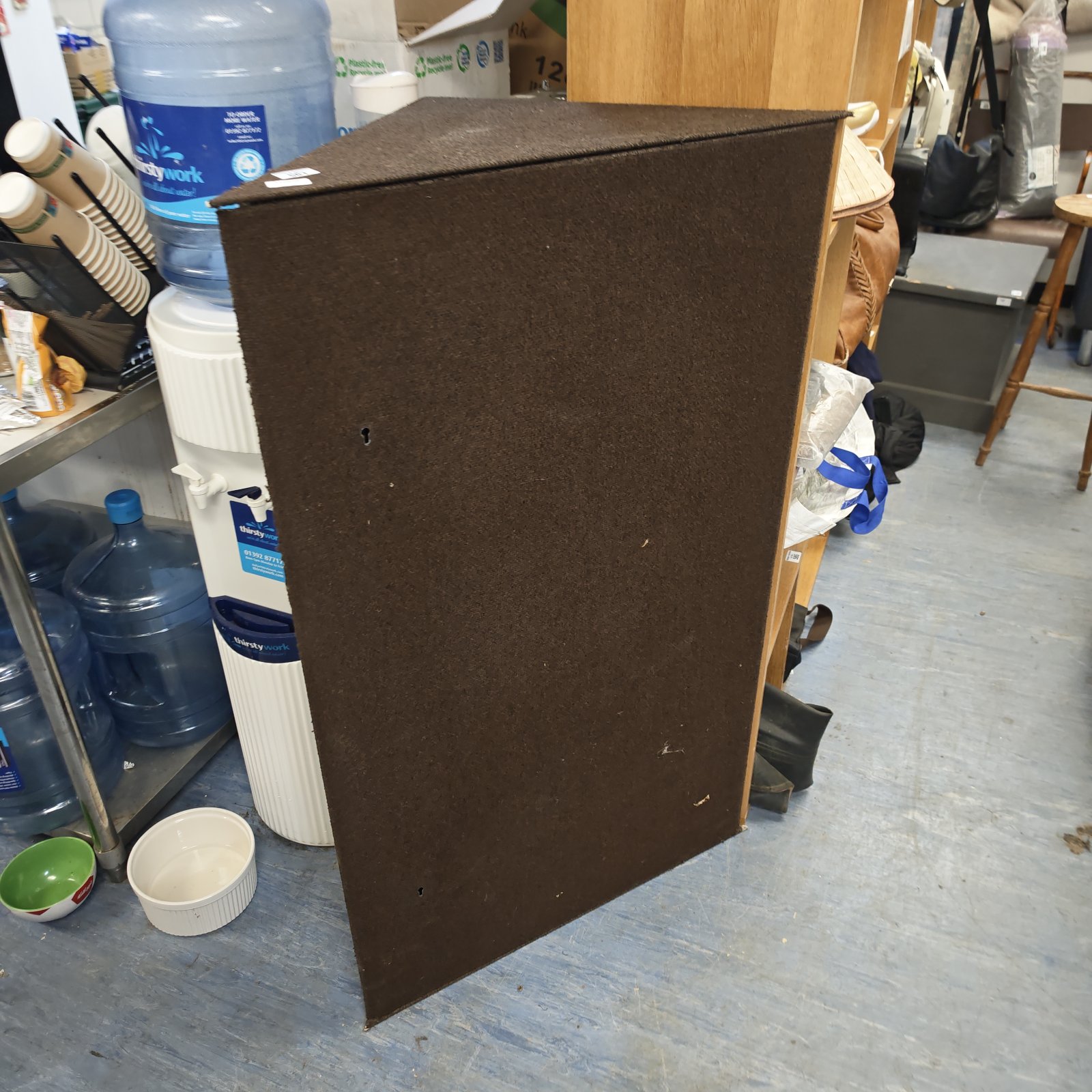 Dark brown fabric cover for a corner gun safe, providing protection.