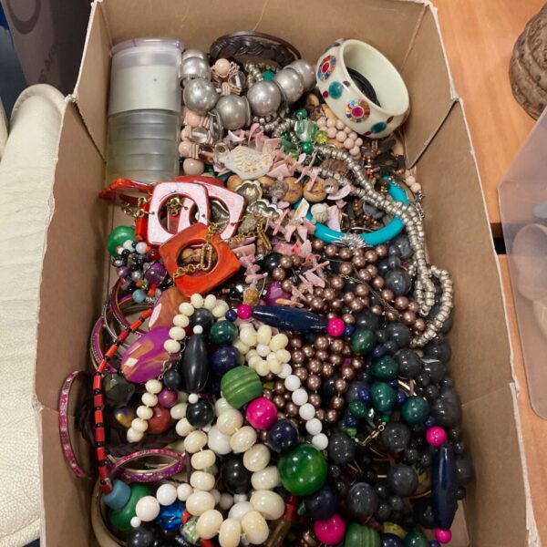 Tray of colourful costume jewellery including bead necklaces and fashion pieces.