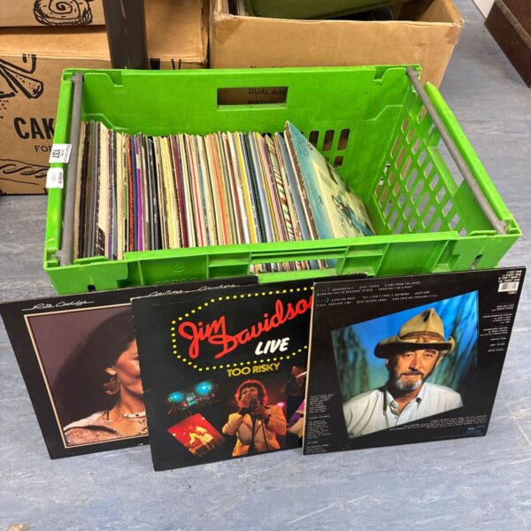Crate filled with a mixed lot of 12 inch vinyl records.