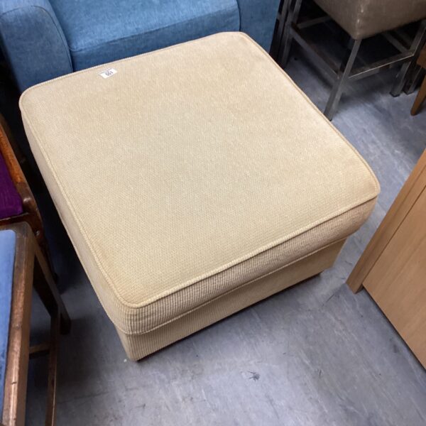 Large cream storage footstool for comfortable seating and hidden storage.