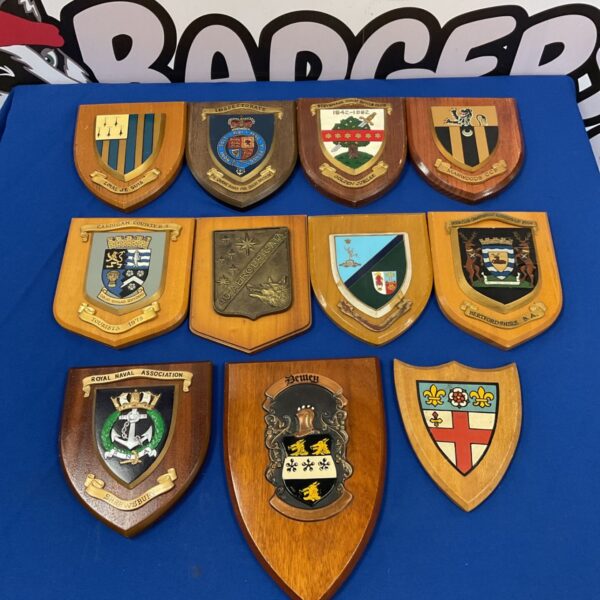 Collection of vintage crested wooden plaques, including a Royal Navy Association crest.