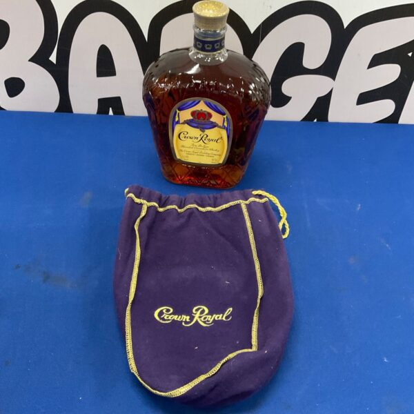 Empty Crown Royal whisky bottle with purple velvet bag.