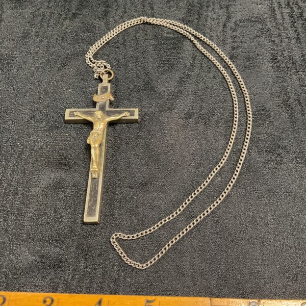 Vintage crucifix necklace with whitemetal and wood detailing on a long chain.