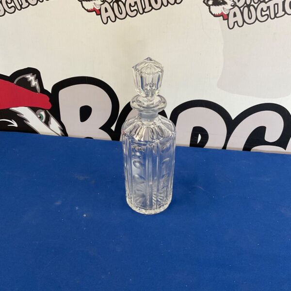 Vintage crystal decanter with stopper, ideal for serving liquor.