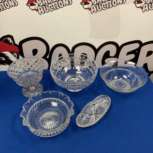 Selection of vintage cut glass bowls with intricate designs.