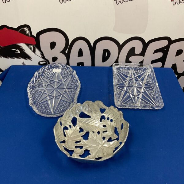 Vintage cut glass cake plates with metal fruit bowl on display.