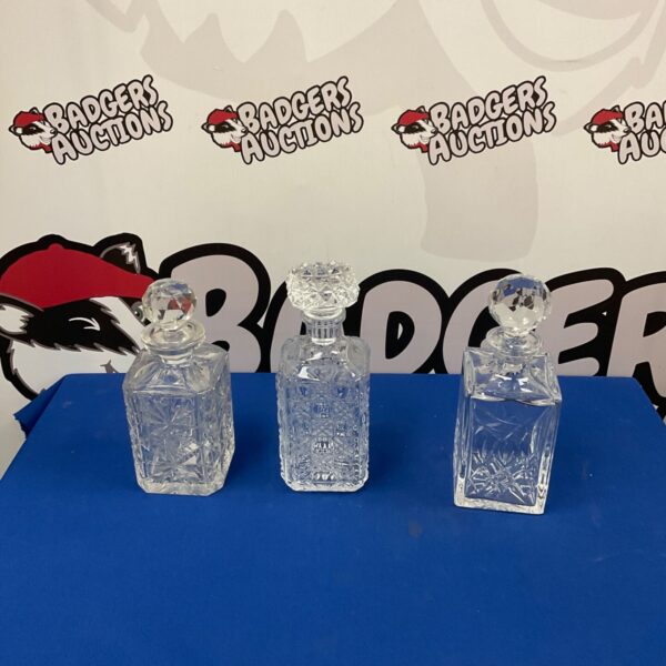 Three vintage cut glass decanters, including a Stuart Crystal decanter.