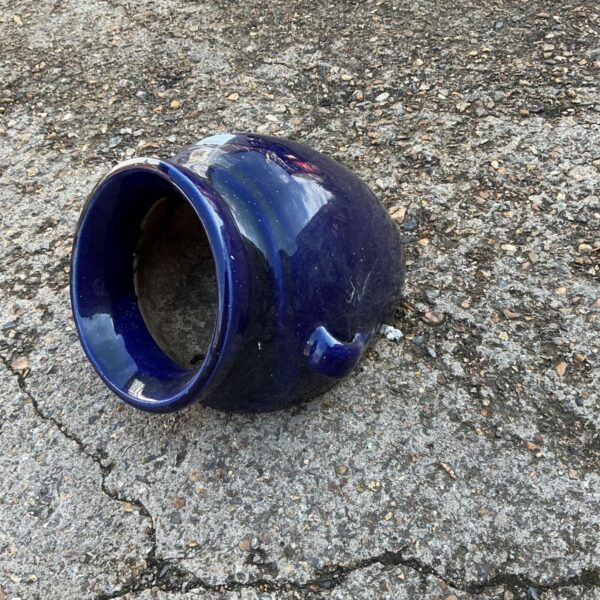 Dark blue glazed ceramic bean pot with handle.