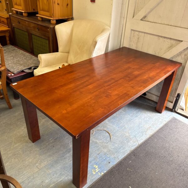 Large dark oak dining table in a vintage setting.