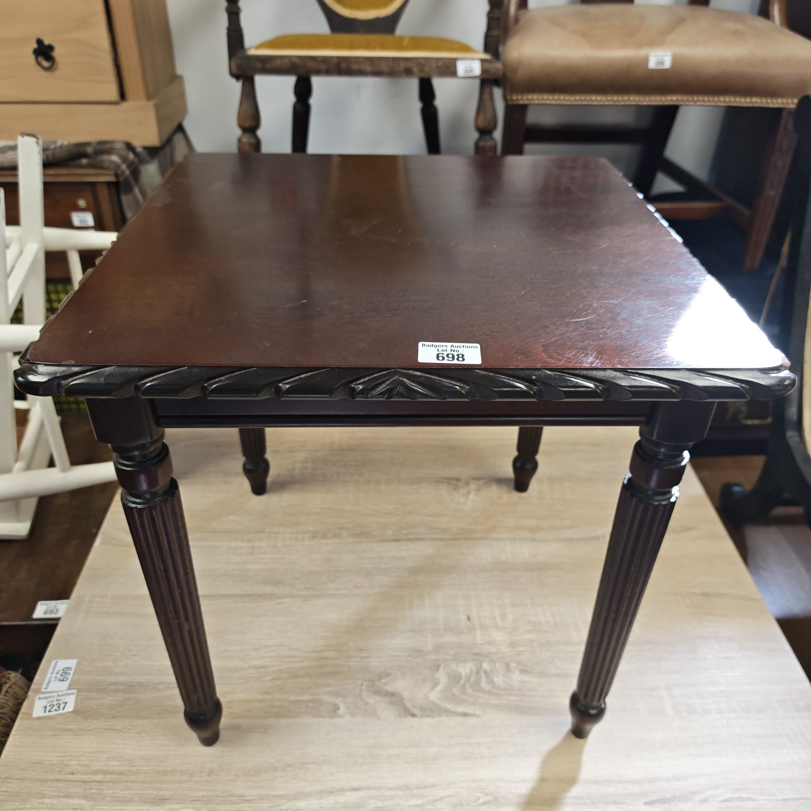 Dark wood Victorian side table with carved legs.