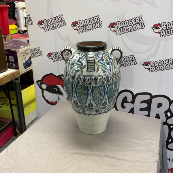 Large decorative pottery urn with vibrant floral design.