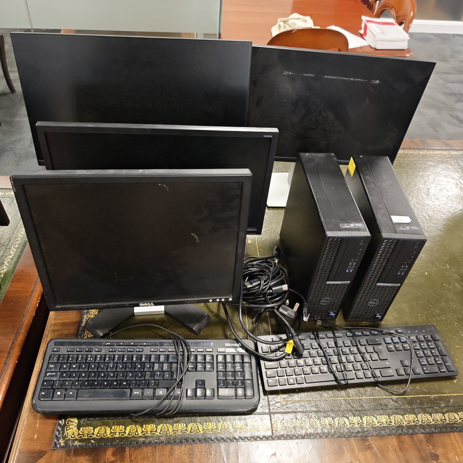 Dell desktop computer setup with multiple monitors and keyboard.