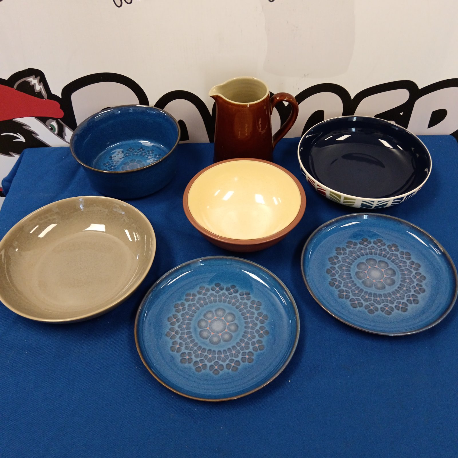 Vintage Denby pottery plates and bowls in earthy tones.