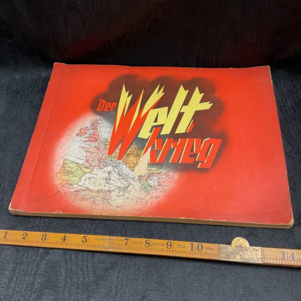 Vintage Der Weltkrieg album cover with red lettering and map.