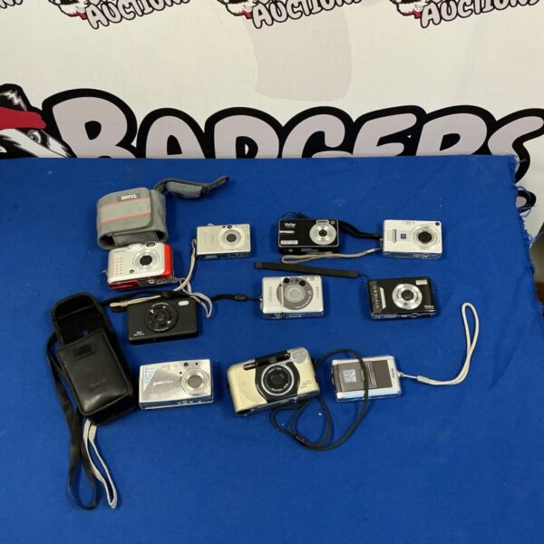 Lot of vintage digital cameras including Benq, Vivitar, and Canon.