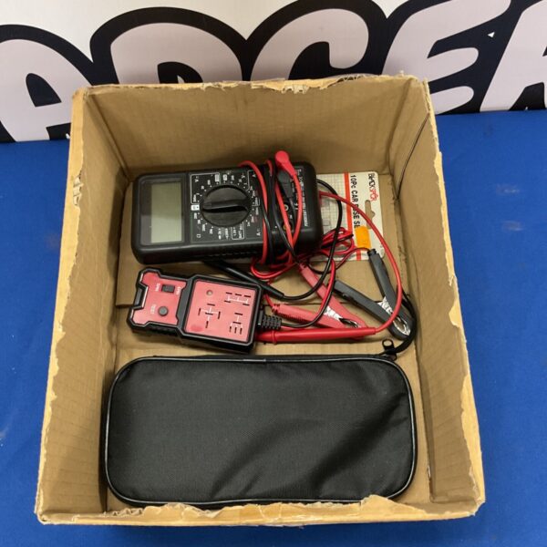 Digital multimeter kit with relay tester and accessories for automotive electrical testing.