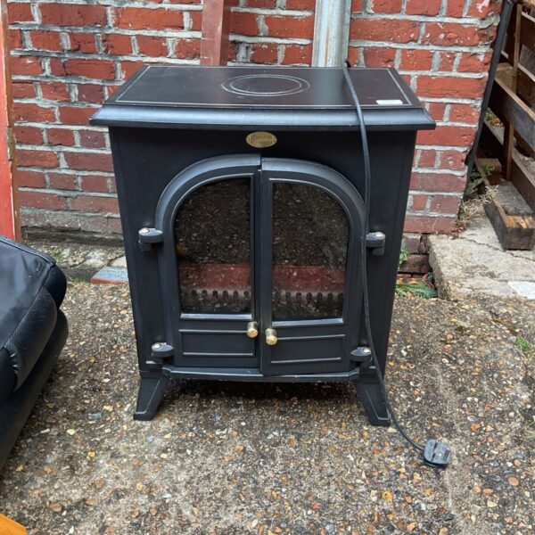 Vintage Dimplex electric fireplace with a dark finish and realistic flame effect.