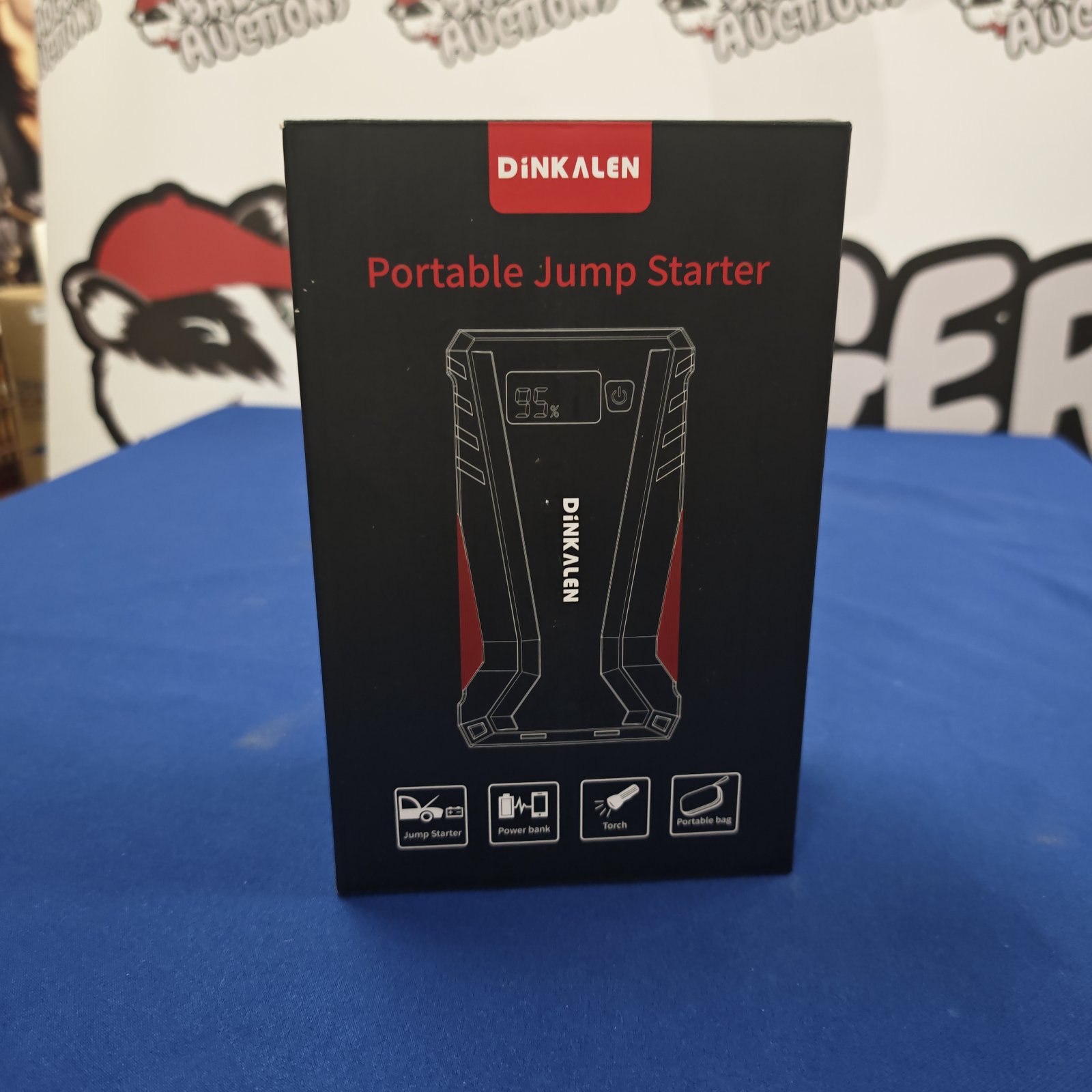 Unopened Dink Alen portable jump starter in original packaging.