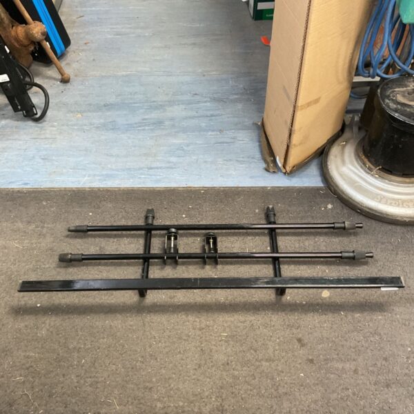 Adjustable metal dog car barrier for vehicle pet safety.
