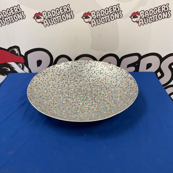 Colourful dotted metal decorative plate for wall display.