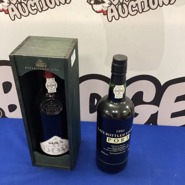 Two bottles of Dow's Port wine in wooden boxes.