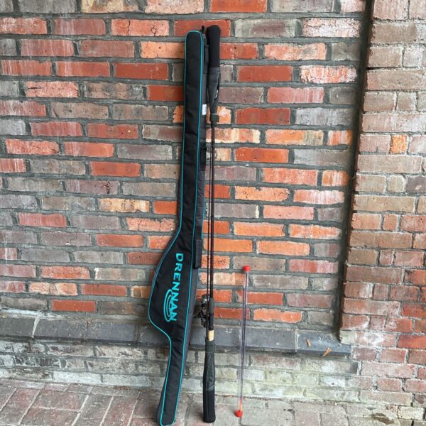 Drennan carp feeder rod in protective sleeve, fishing equipment.