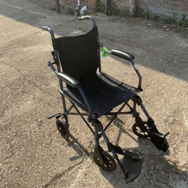 Drive Medical Travelite transport wheelchair, a lightweight mobility aid.