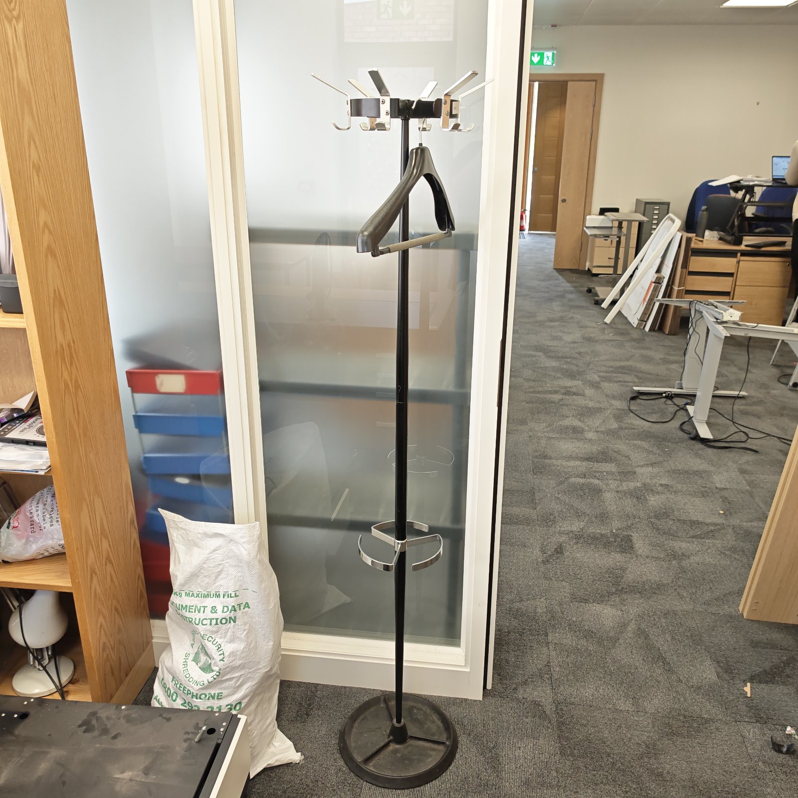 Vintage Du-al coat and umbrella stand in a hallway setting.