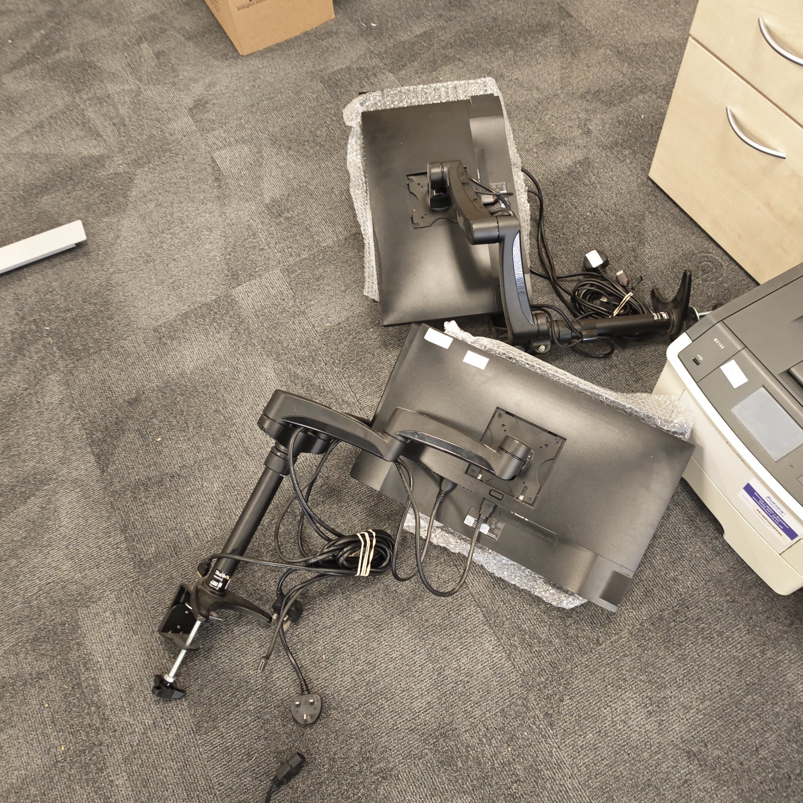 Dual monitor stand with two Dell monitors on a desk.