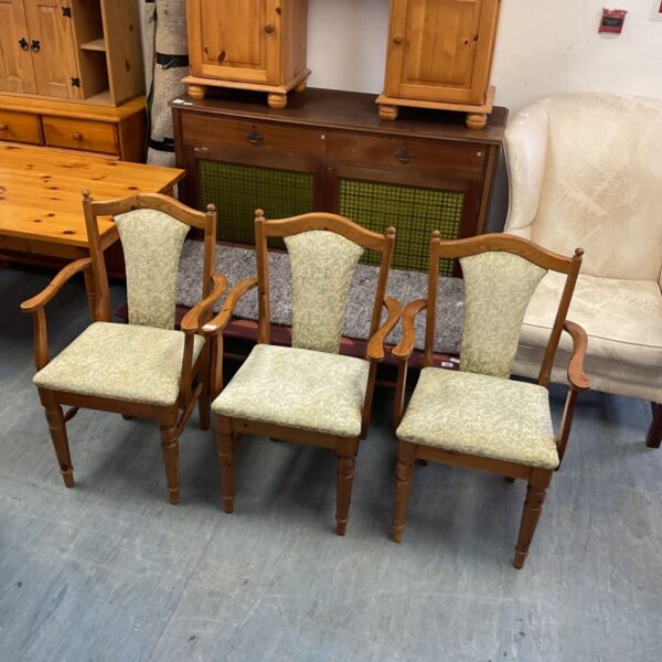 Three vintage Ducal pine dining chairs with floral padded seats.