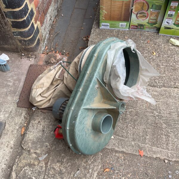 Side view of a used centrifugal dust extractor blower.