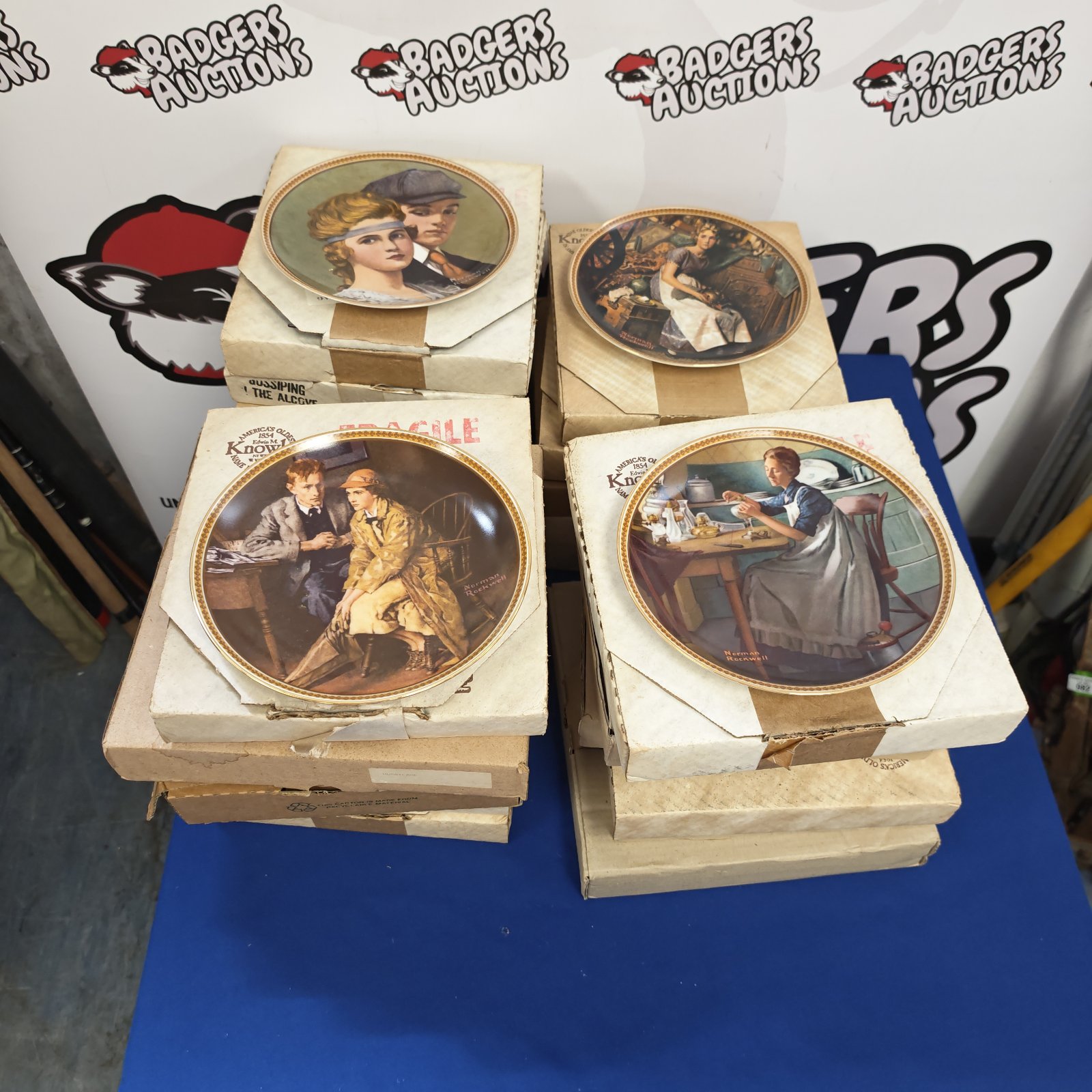 Collection of vintage Edwin M. Knowles decorative plates for display.