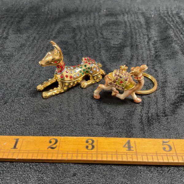 Gold plated Egyptian dog and camel keyrings with jewel embellishments.