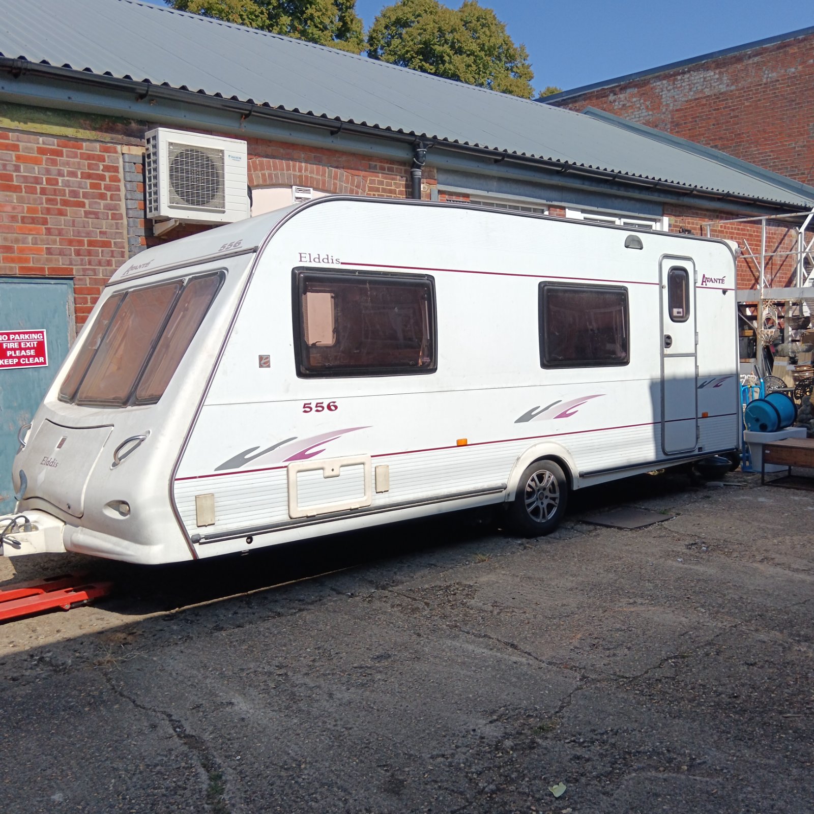 White Elddis Avante 556 caravan parked outside a building.