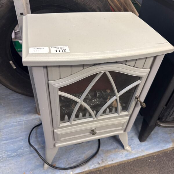 Cream electric fireplace heater with decorative front panelling.