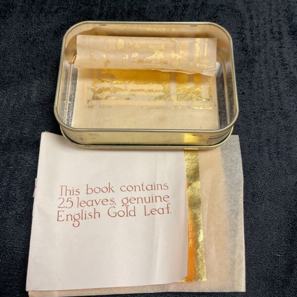 Antique tin containing a book of English gold leaf for gilding.