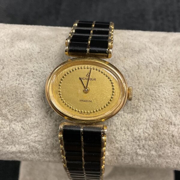 Vintage Excaliber ladies gold wristwatch with a classic dial.