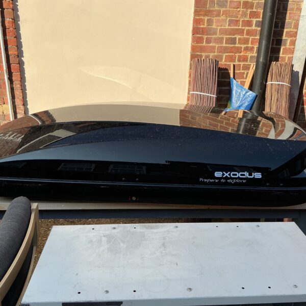Black Exodus roof box for car storage, showing exterior condition.