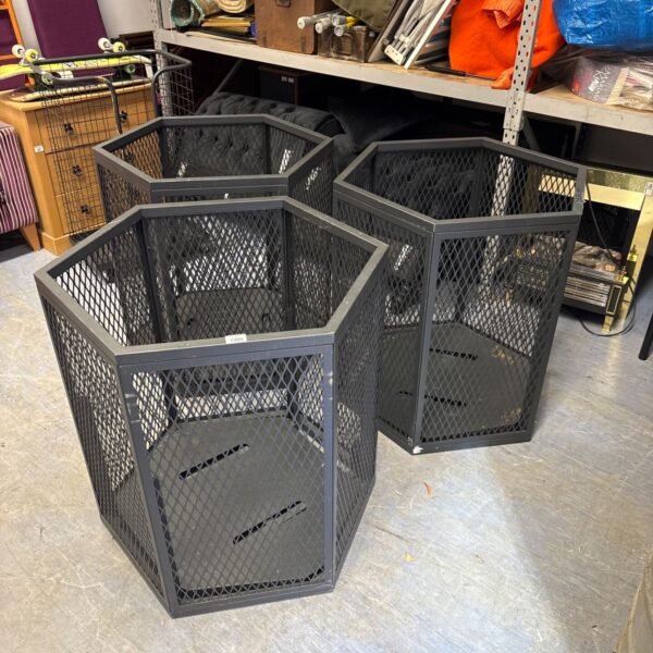 Three hexagonal expanded metal bins for industrial storage.