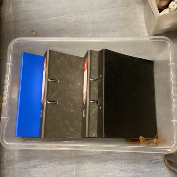 Four empty file folders with ring binders for document storage.