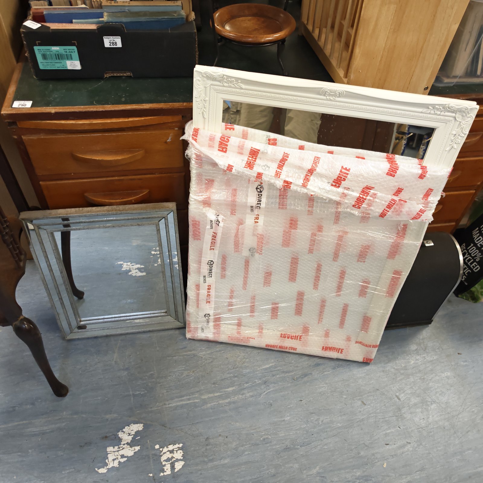 Vintage pair of fleur de lis mirrors, one unused in packaging.