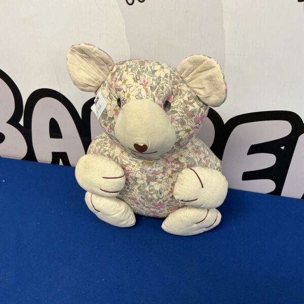 Close-up of floral bear plush toy with custom design.