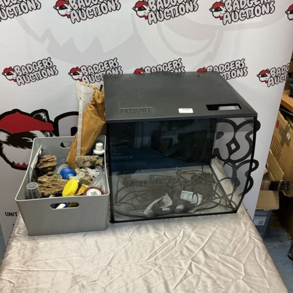 Fluval fish tank with box of aquarium equipment and fish food.
