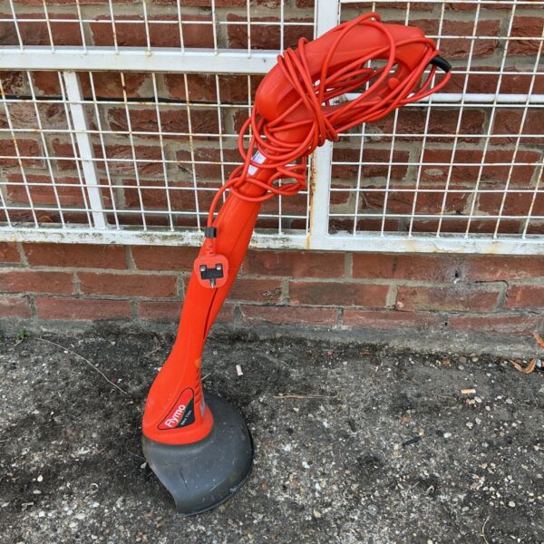 Red and black Flymo Easy Trim electric garden strimmer.