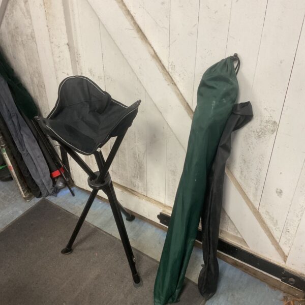 Two folding camping stools, one open and one folded, ready for outdoor use.