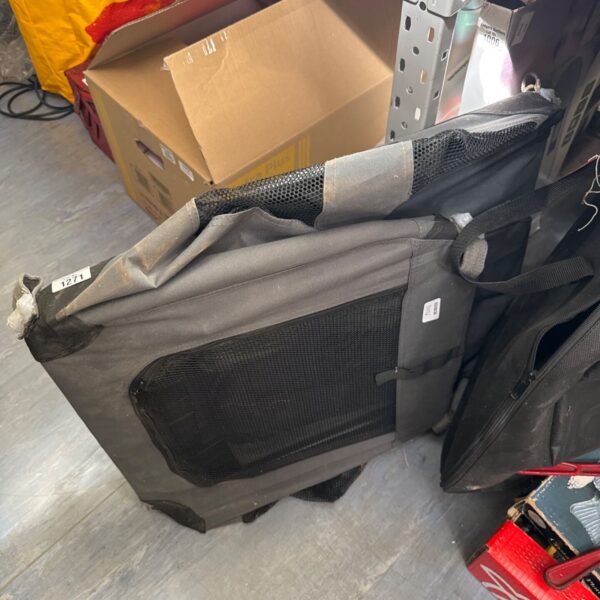 Collapsed folding canvas pet crate for animal transport.
