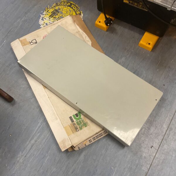 Front view of a vintage folding metal stand.