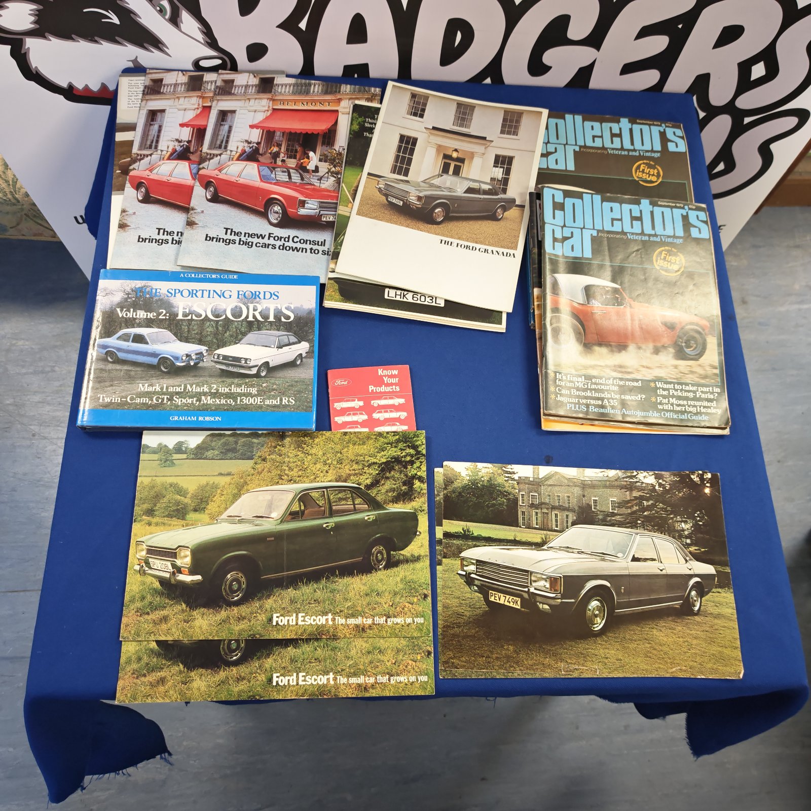 Stack of vintage Ford brochures and collectors guides.
